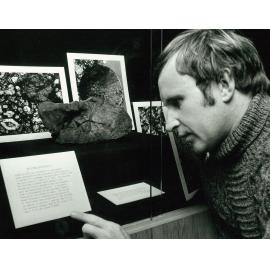 Robert Stewart examining meteorite fragment, undated